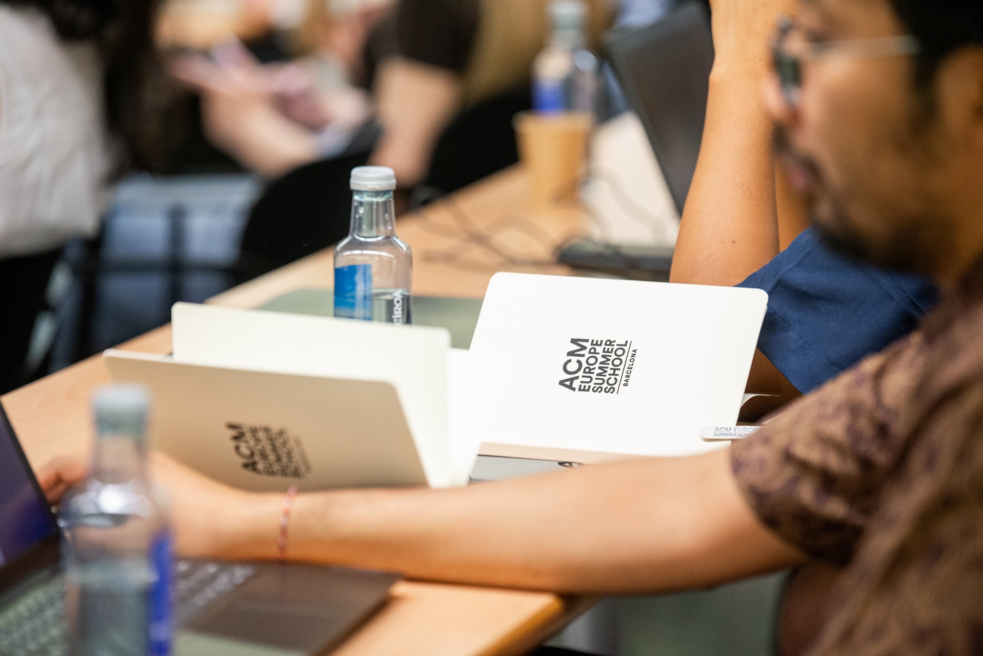 Photo of students taking notes during the 2025 ACM Europe Summer School on HPC & AI